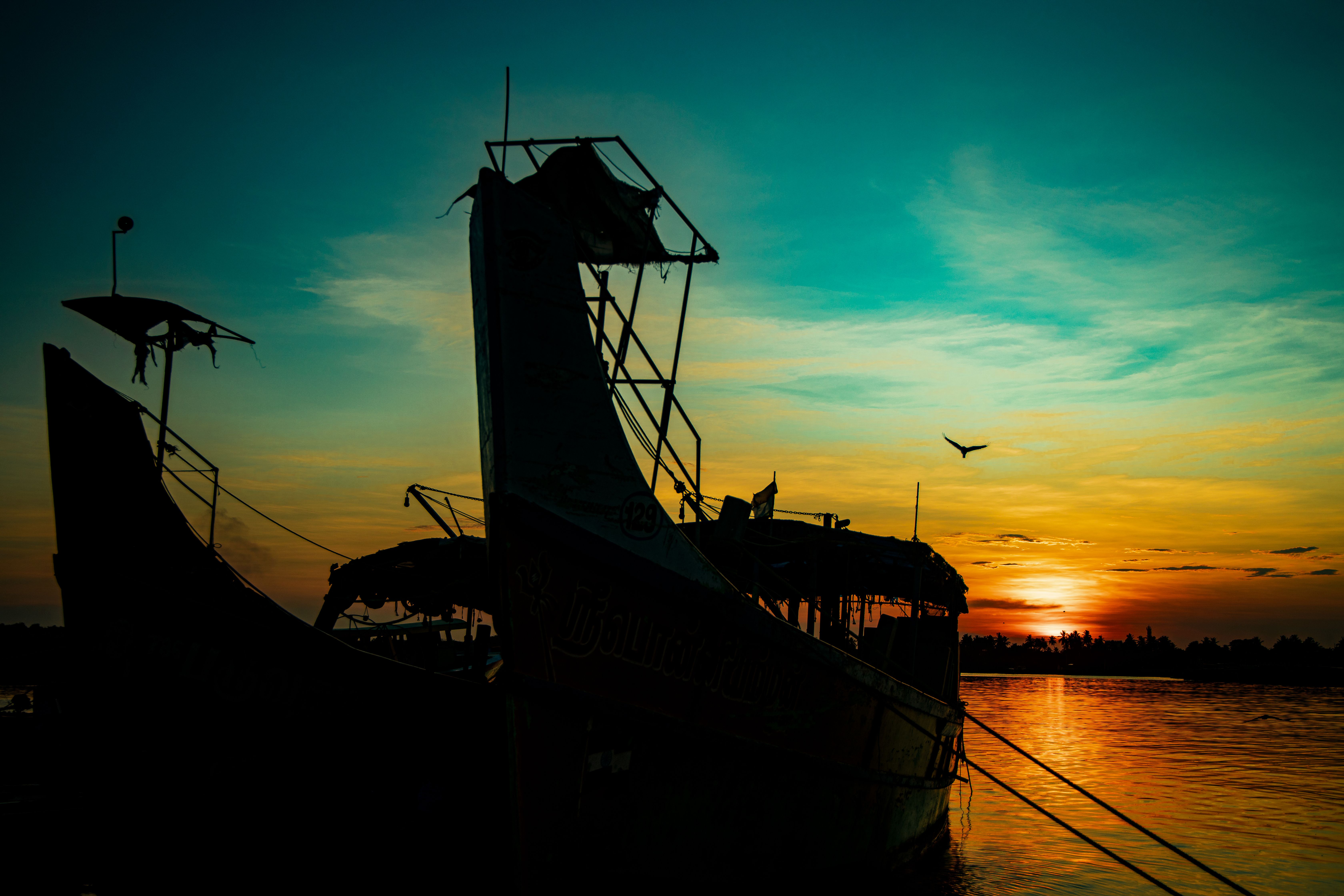 Silhouette of Boats on the Sea during Sunset · Free Stock Photo