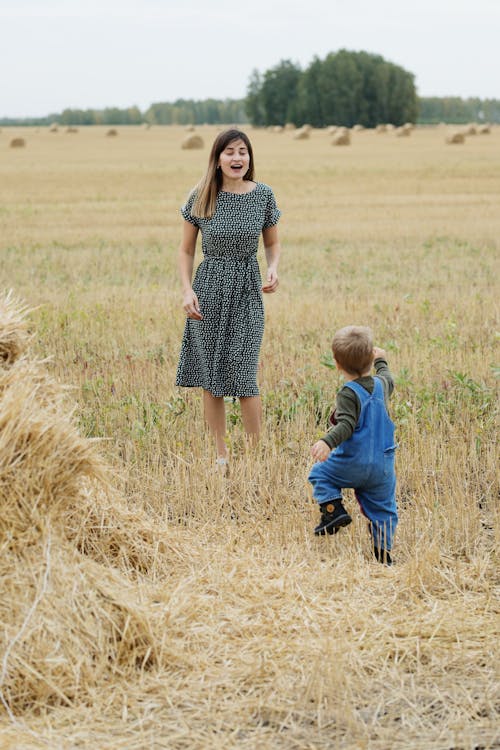 Mother and Child Playing on the Hay Field