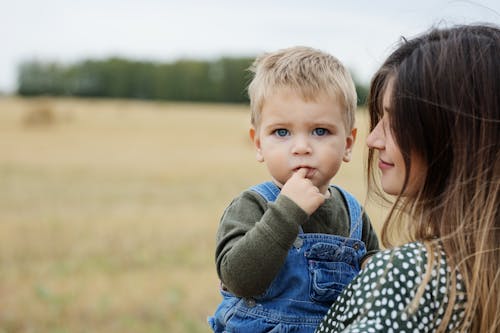 Close-Up Shot of a Toddler and His Mother