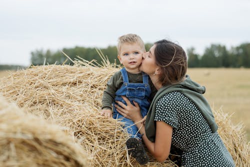 Close-Up Shot of a Mother Kissing His Son 