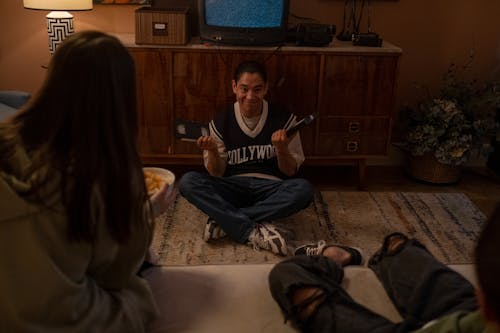 Free Three friends choosing VHS movie to watch Stock Photo