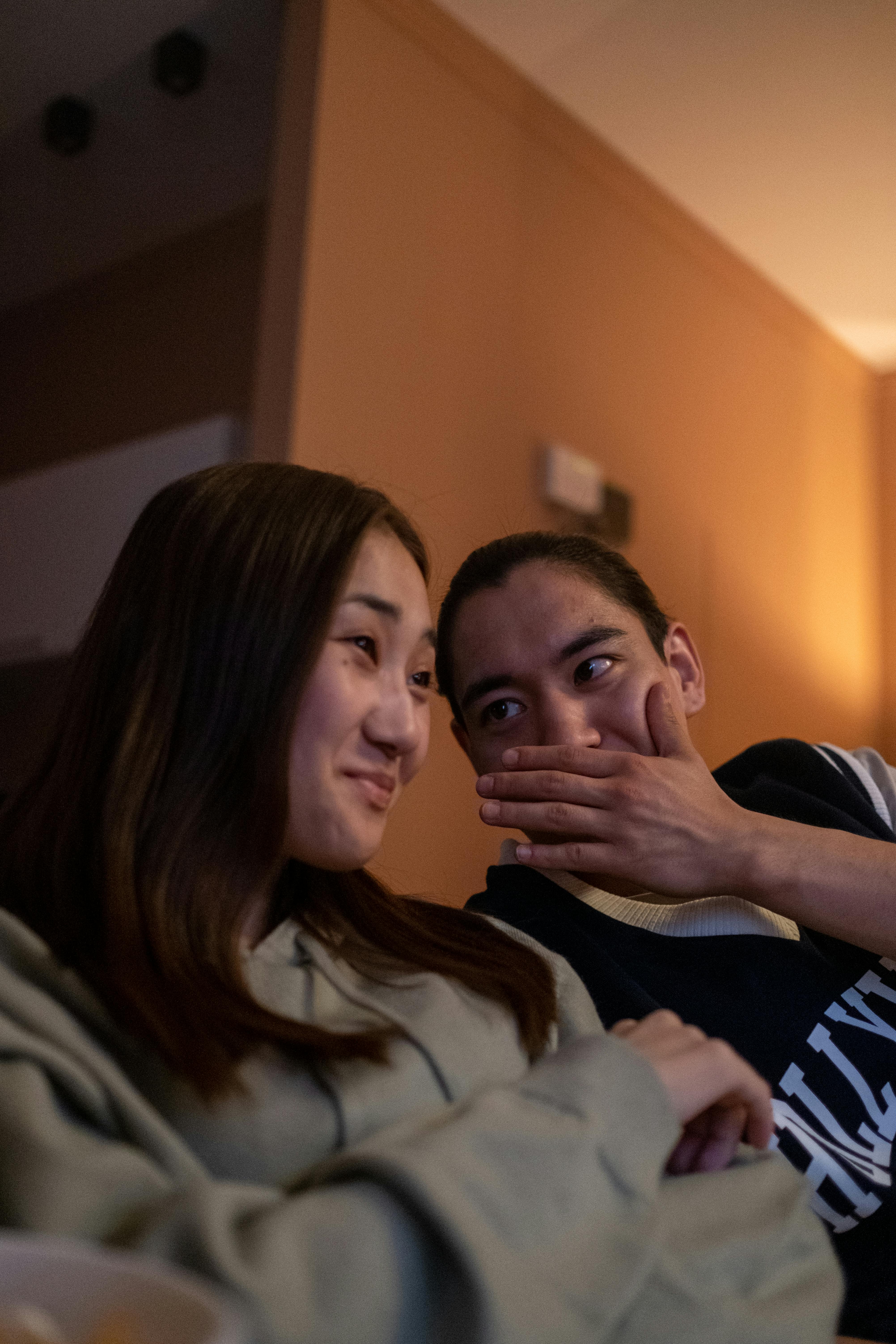 man and woman chatting white watching movie