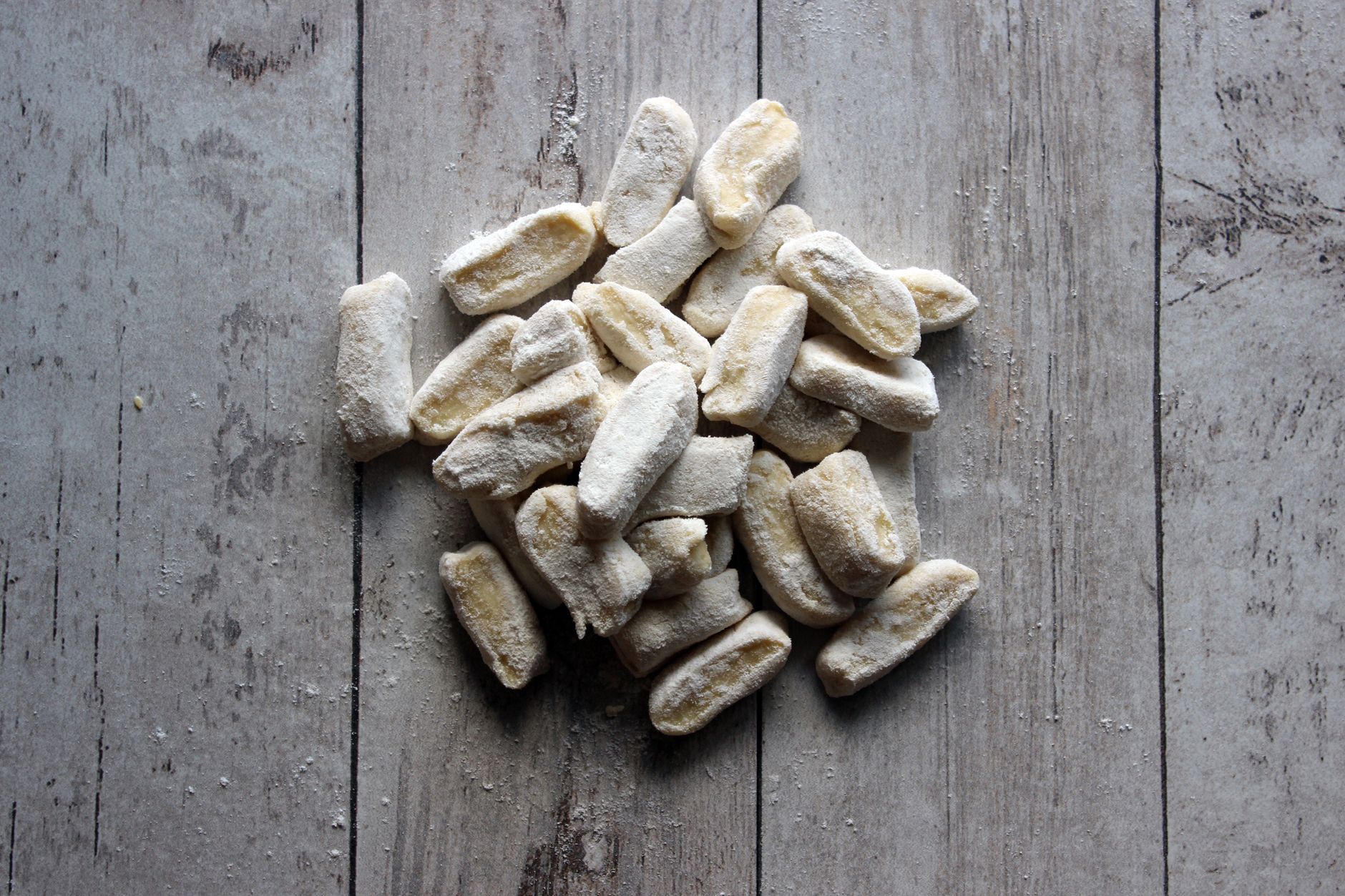 Close-up of sautéed shrimp and arugula on gnocchi