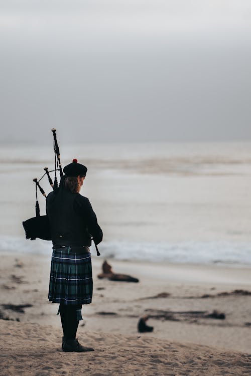 Free Person in scottish kilt playing bagpipes Stock Photo