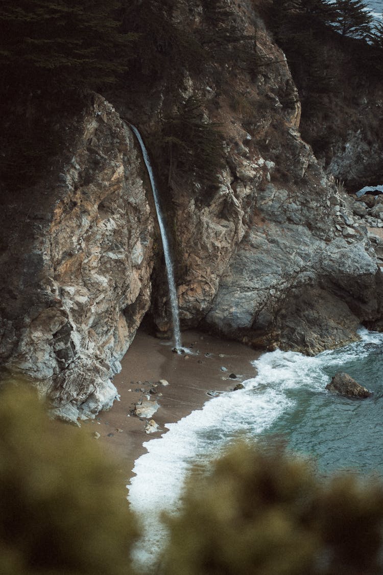 Photo Of Small Waterfall On Beach