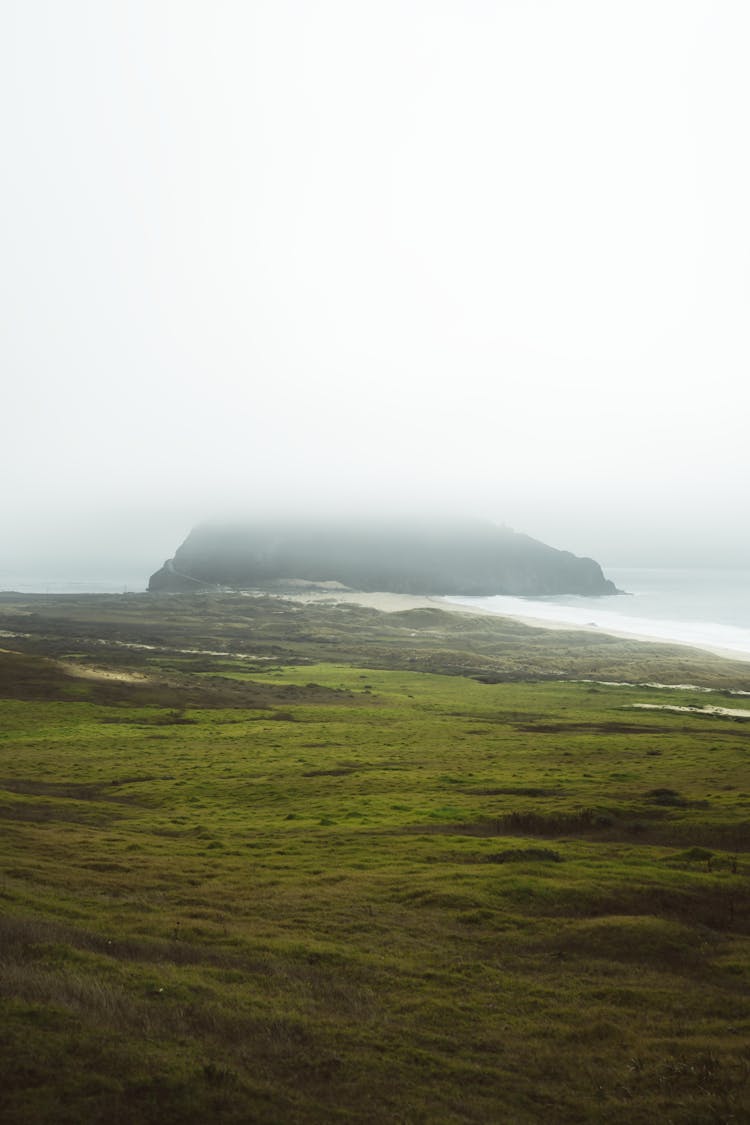 Foggy Landscape With Island In Background