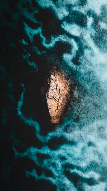 Stunning aerial shot of a rocky islet in the turquoise waters off Okinawa, Japan.