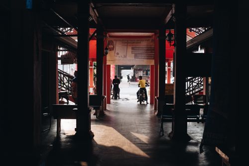 Free Shadowy market passageway with people in Terengganu, Malaysia. Stock Photo