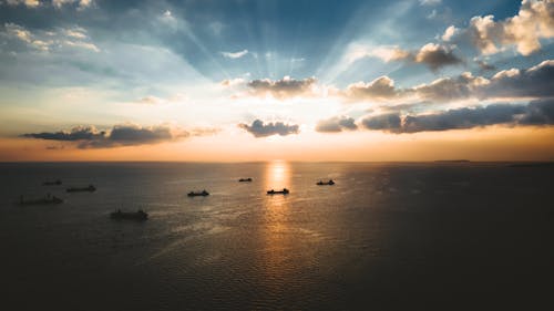Free Silhouette of Boats on the Sea during Sunset Stock Photo