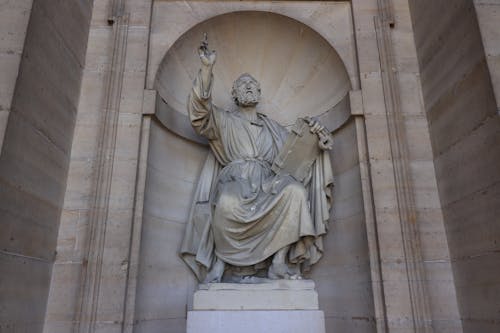 Sculpture of a Man Holding a Book