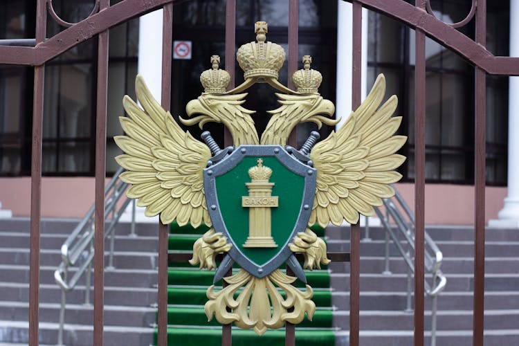 Golden Emblem On Building Fence