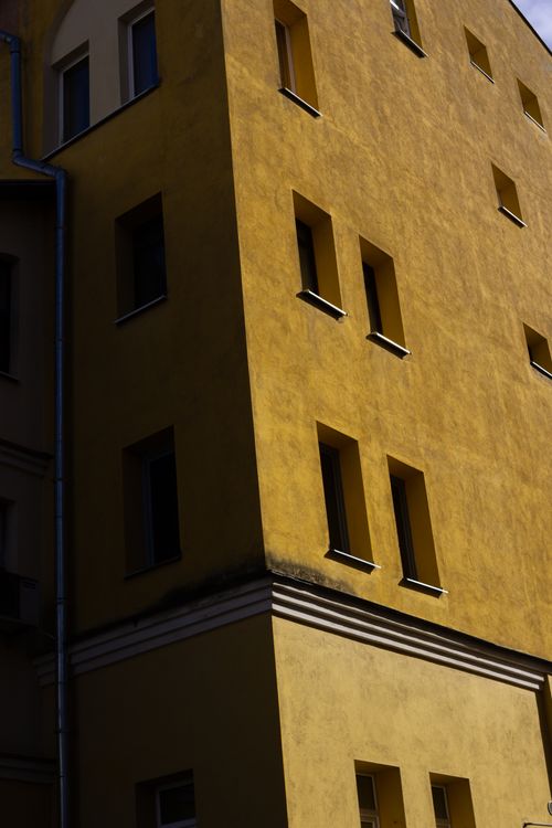 Free Tall yellow building with multiple windows, showing modern architectural design. Stock Photo