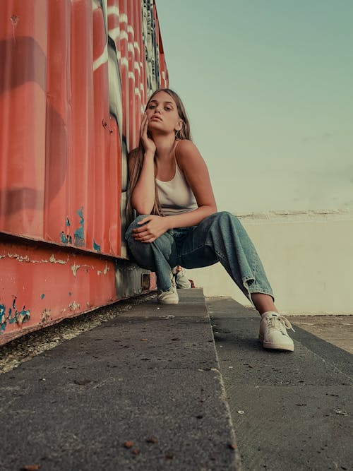 Woman in White Top and Denim Jeans