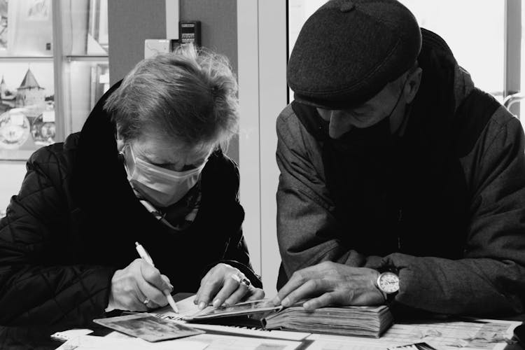 Woman And Man Filling Out Papers