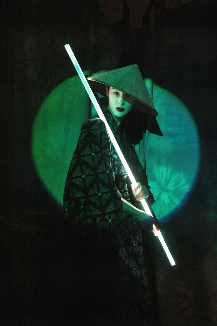 An Asian Actress Holding A Light Stick And Looking At Camera 