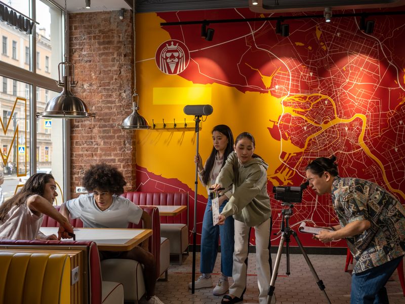 Film crew shooting branded content inside a modern restaurant