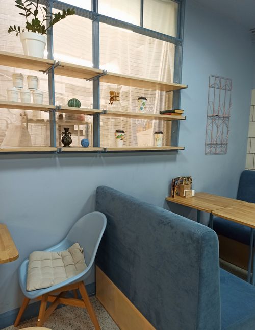 Free Inviting café interior in Novosibirsk, featuring modern furniture and soft blue decor. Stock Photo
