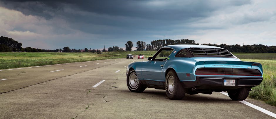 Blue Coupe on Brown Concrete Road