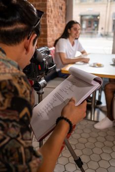 Filmmaker captures casual meetup of friends at a cafe, enhancing the teamwork and enjoyment vibe.