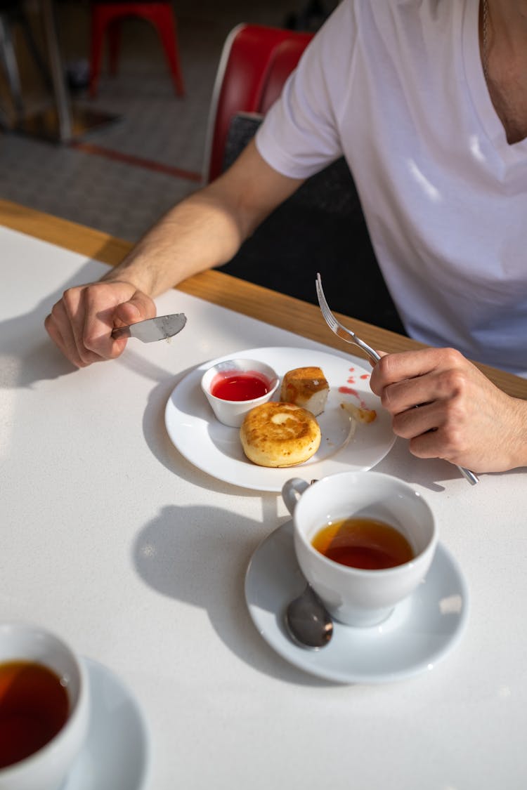 An unrecognizable Person Eating A Breakfast 