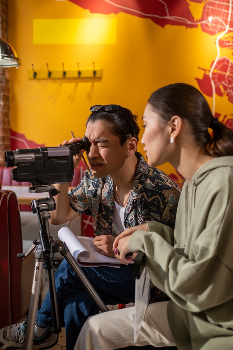 A Man And A Woman Working Behind The Scene