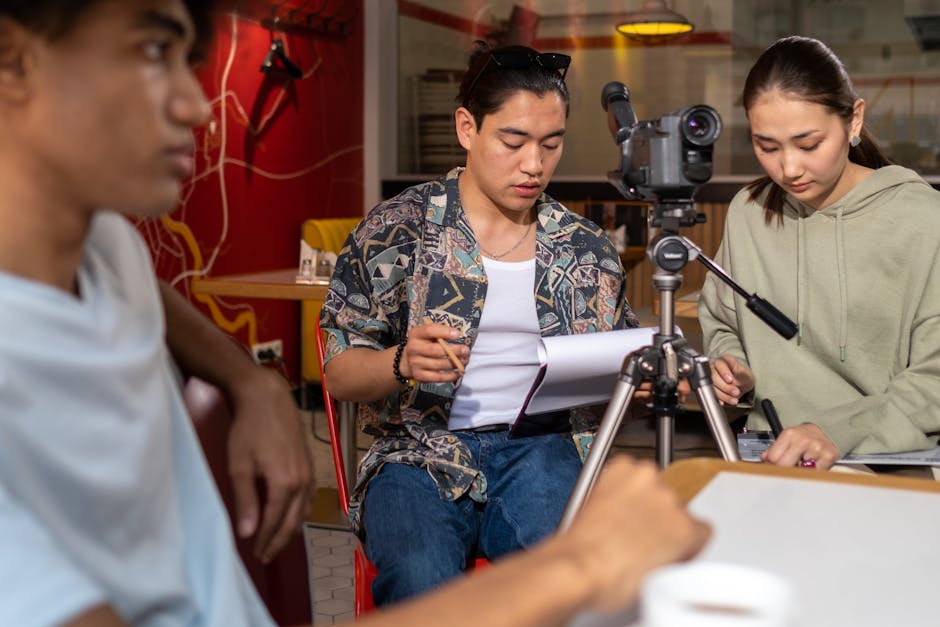 Team of young adults planning a film project in a vibrant indoor studio.