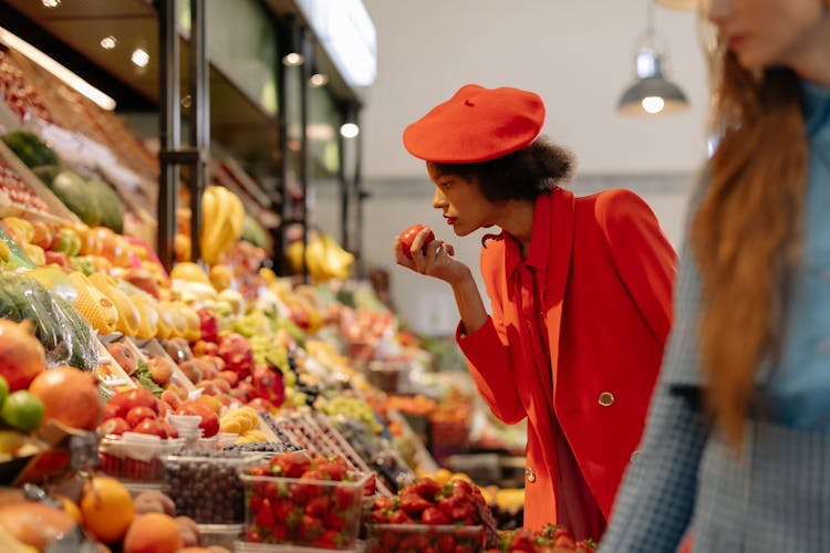 Woman In Red Coat Shopping For Fruit