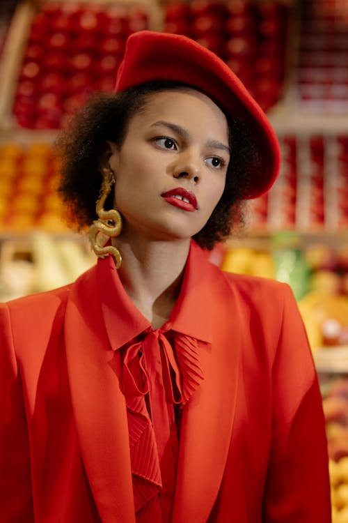 Woman in Red Beret Wearing Gold Dragon Earring