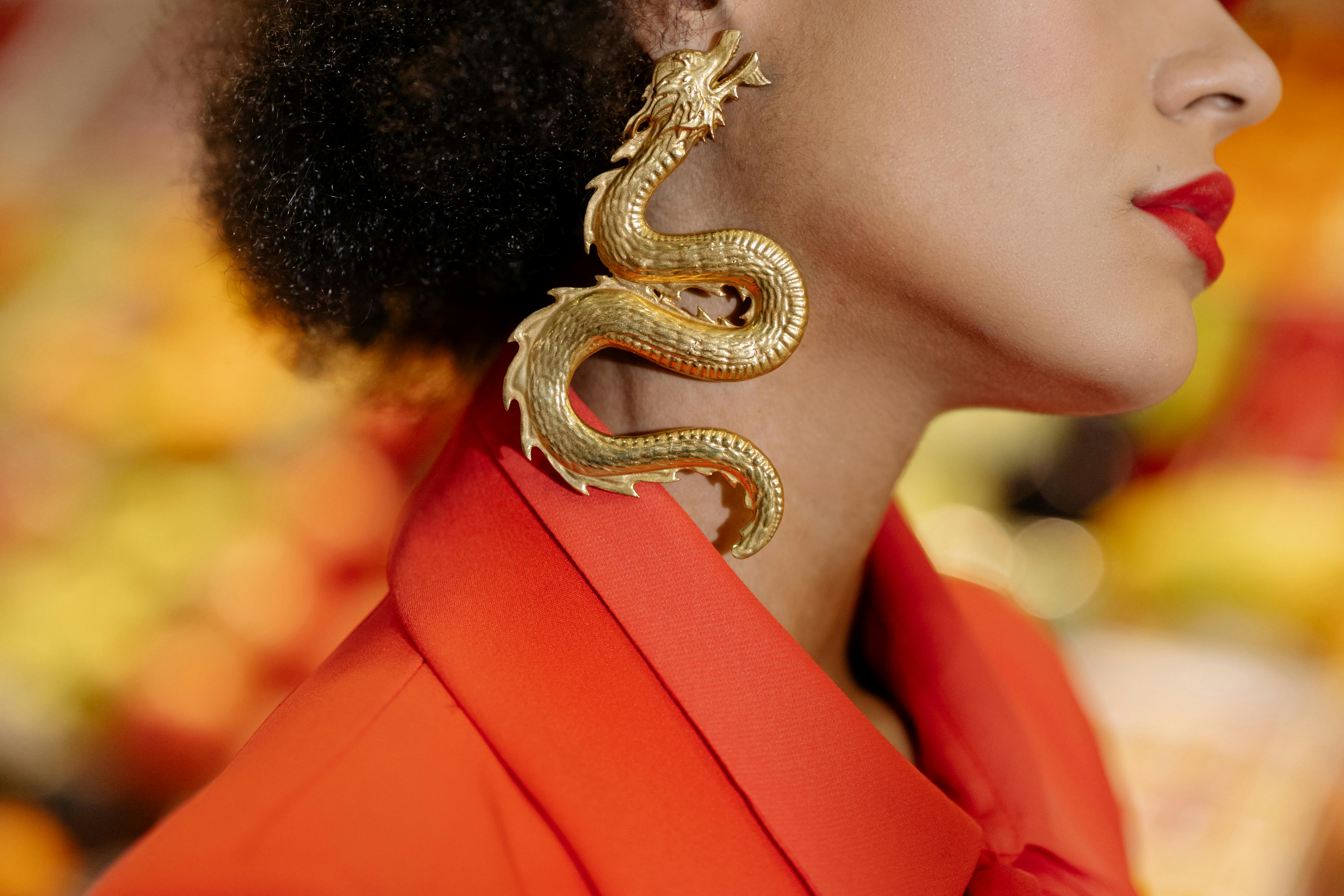 woman wearing gold dragon earring
