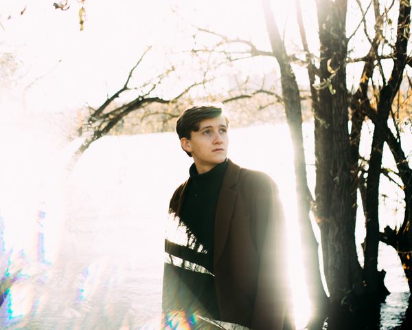 Portrait of man standing in dark overcoat