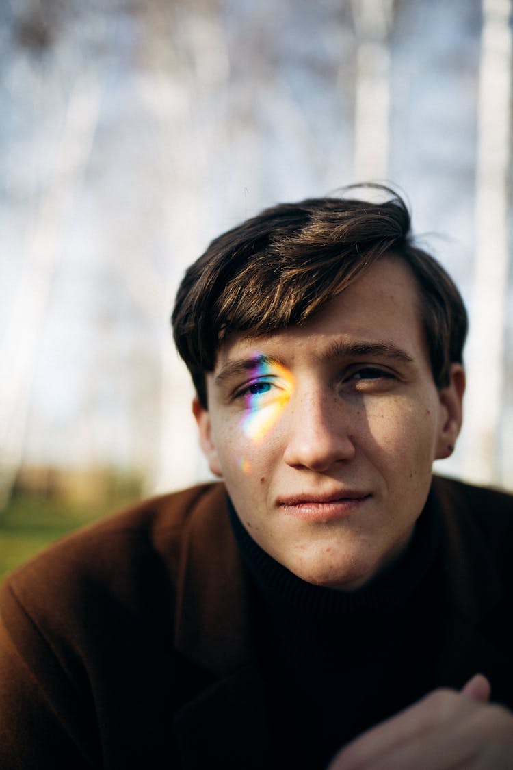 Portrait Of Black Hair Man With Spectrum Of Light On Eye