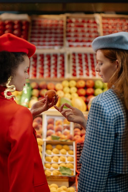 Woman in Red Blazer and Red Beret Hat Holding Round Fruit