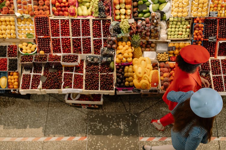 Women Walking On The Street Near Fruits Store