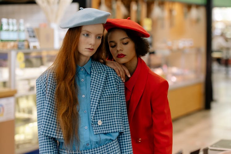 Fashionable Women In Beret Hats Standing In The Supermarket