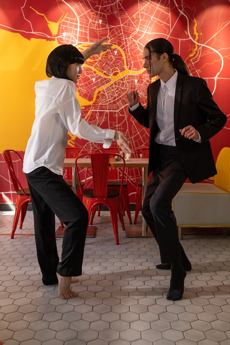 Couple Dressed As Movie Characters Dancing In A Cafe