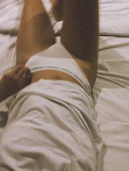 Relaxed morning in bed with soft blur effect. Subtle and serene lifestyle capture.