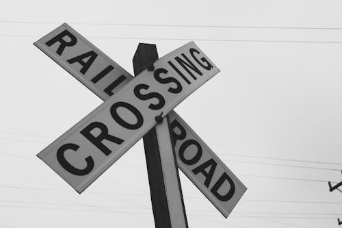 Free Grayscale Photography of Railroad Crossing Signage Stock Photo