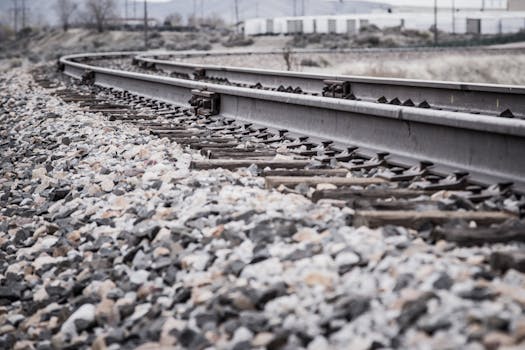 Photo by Brett Sayles Close-up view of a curved railroad track in a rocky landscape.
