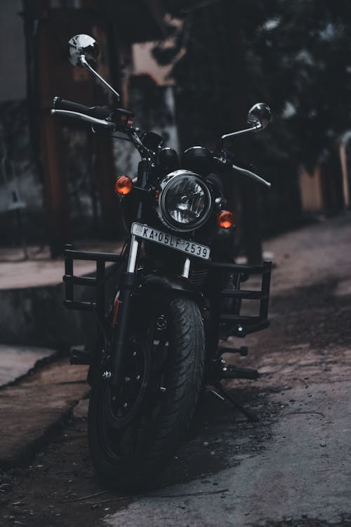 A Black Motorcycle Parked on the Street