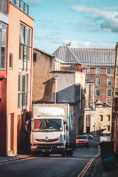 Photograph of a White Truck Near a Building