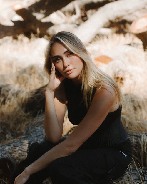 A blond female model looking at camera outdoors 