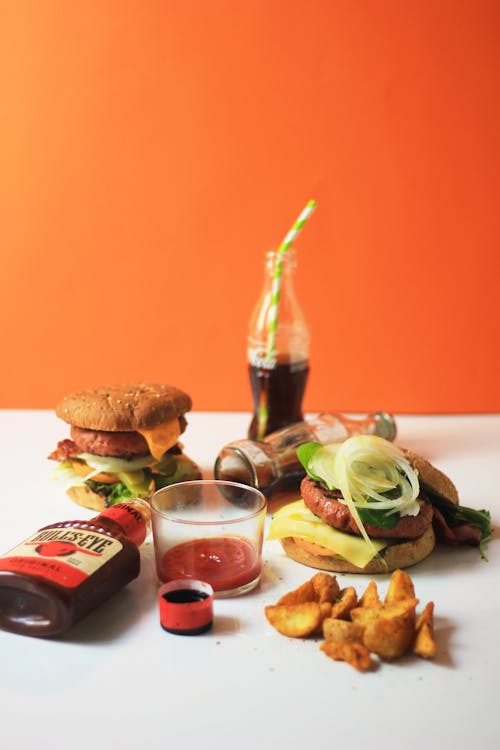 Burgers and Soft Drinks on a White Surface