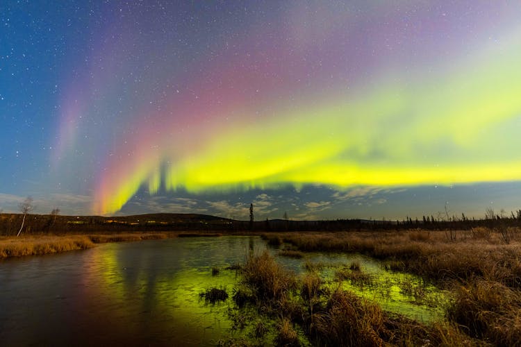 Aurora Borealis In The Sky Over A River