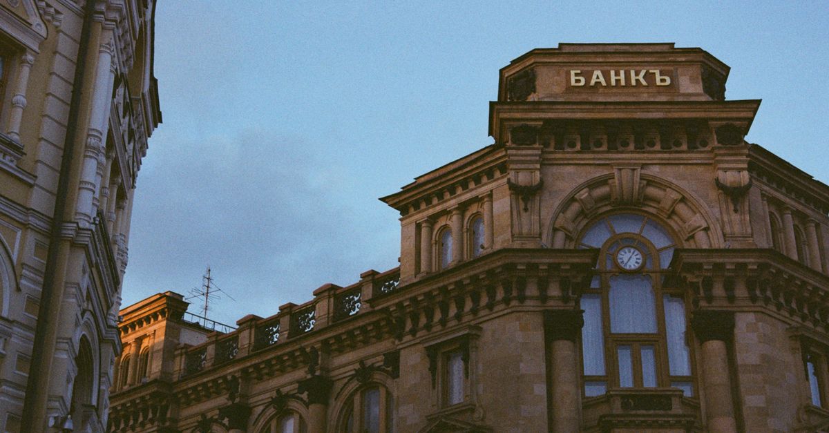 Classic architectural style of a historic bank building under clear blue sky.