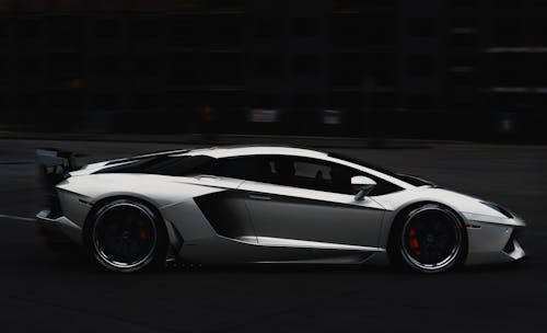 Grayscale Photo of a Lamborghini Aventador Car on the Road