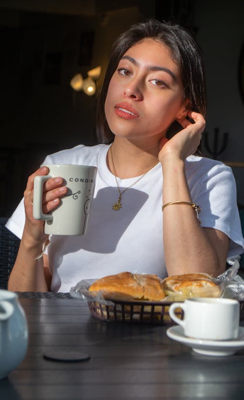 Beautiful Woman in White Shirt holding a Mug 