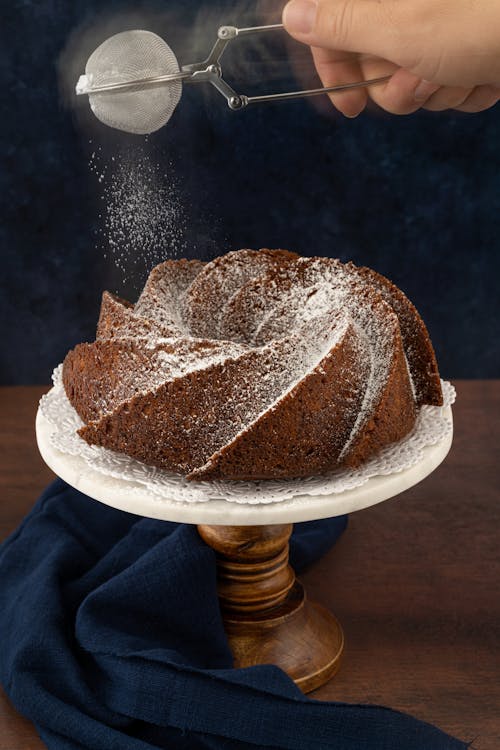Person Dusting White Powder on Top of the Cake · Free Stock Photo