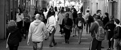 Free Grayscale Photography of People Walking Near Buildings Stock Photo