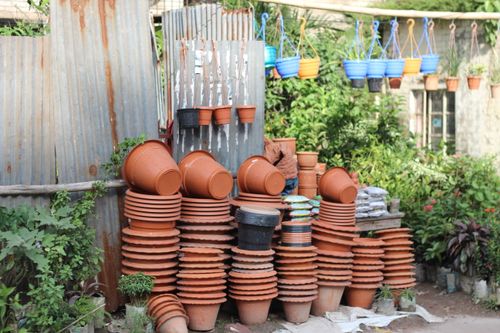 Free A variety of stacked and hanging garden pots outdoors, showcasing vibrant colors and textures. Stock Photo