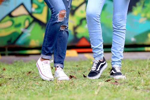 Free Person's Wearing White and Black Low-top Sneakers Stock Photo